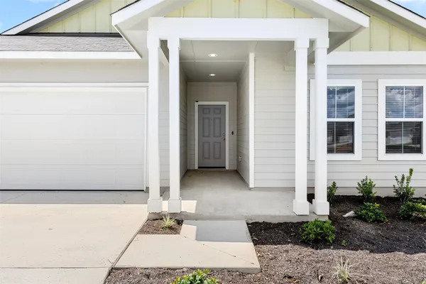 a view of a house with potted plants