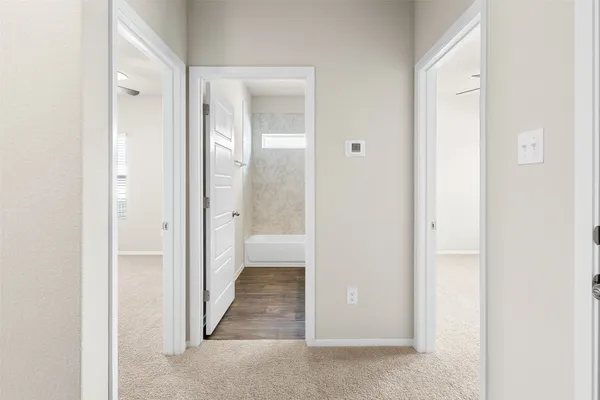 a view of a bathroom from the hallway with toilet