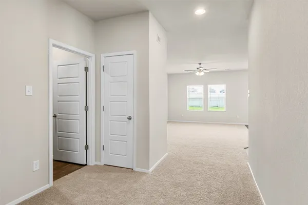 an empty room with windows and closet