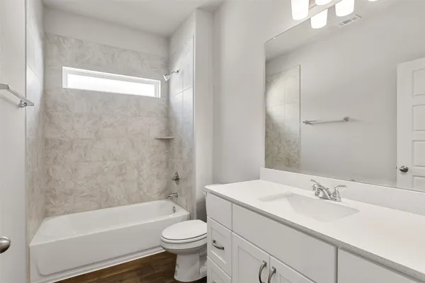 an empty room with a chandelier fan and windows