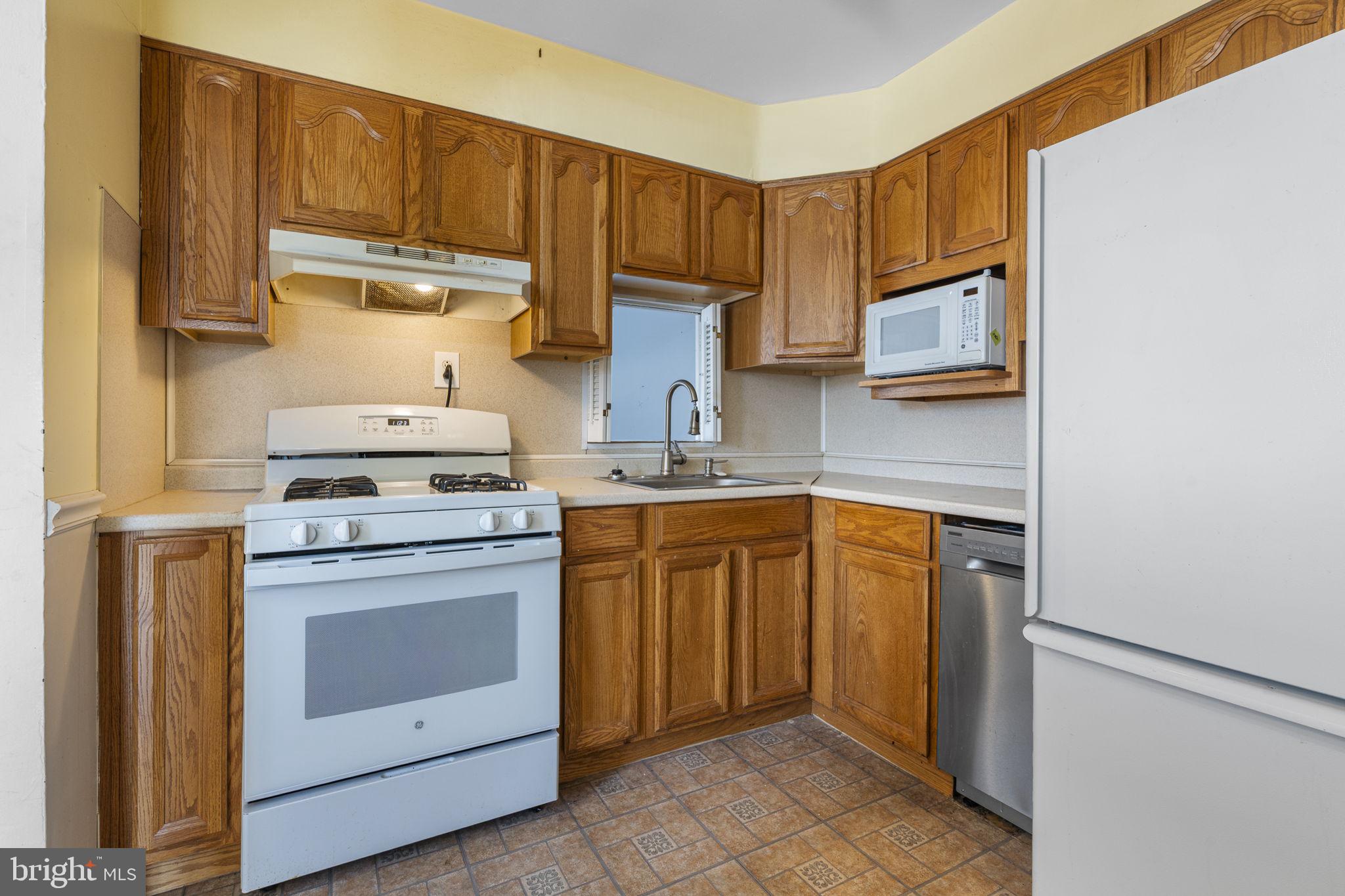146 Ross Road King of Prussia, PA 19406 - Photo 7 of 27 a kitchen with stainless steel appliances granite countertop a stove microwave and cabinets