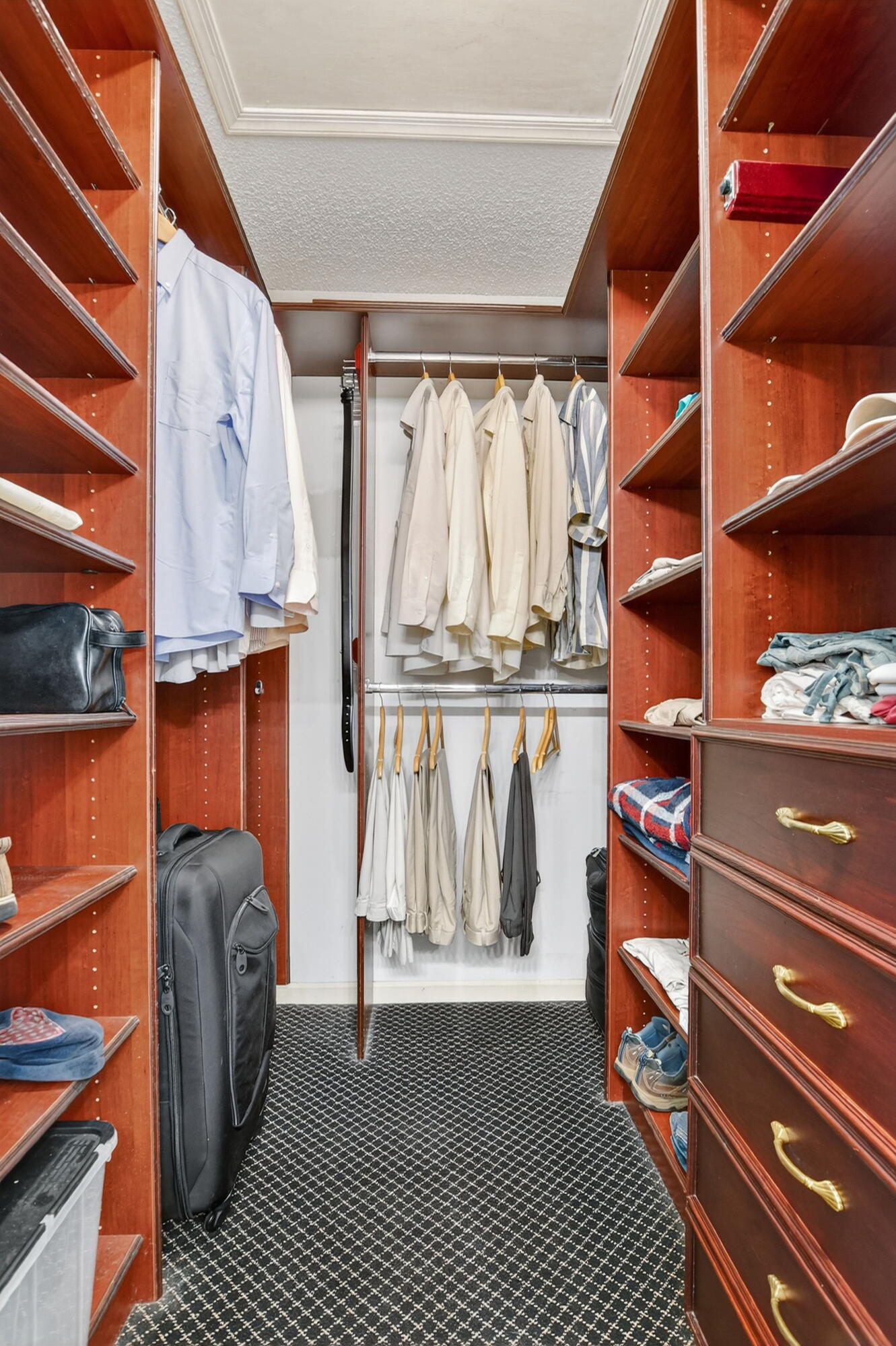380 Northwest 67th Street, Unit 207 Boca Raton, FL 33487 - Photo 13 of 34 a view of walk in closet with clothes and shoes