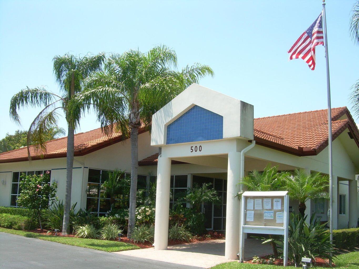 380 Northwest 67th Street, Unit 207 Boca Raton, FL 33487 - Photo 24 of 34 a view of a house with a yard and plants