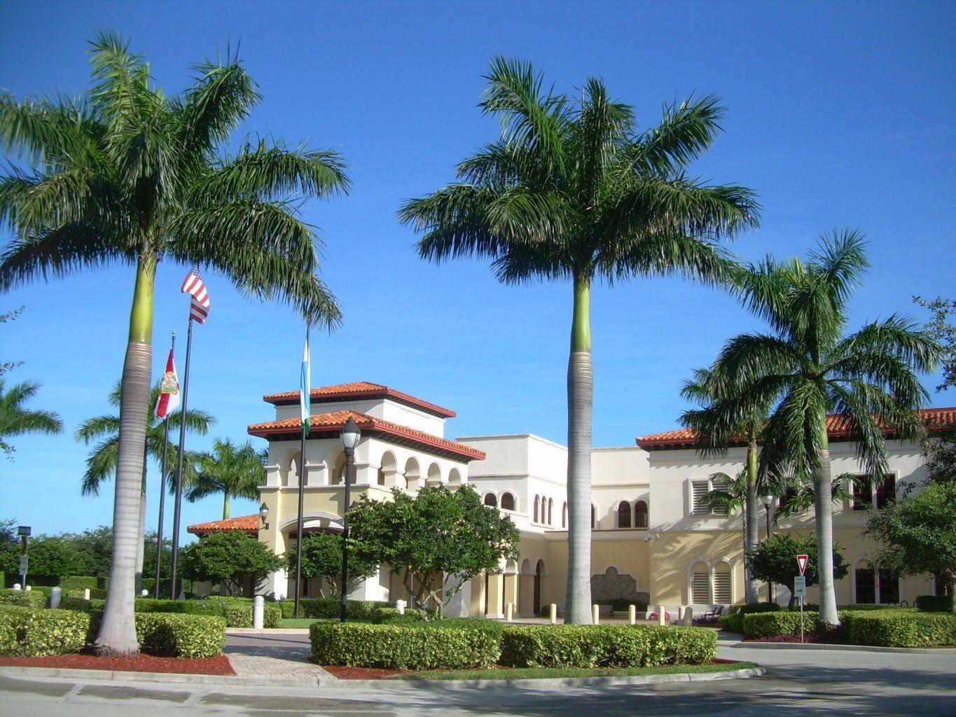 380 Northwest 67th Street, Unit 207 Boca Raton, FL 33487 - Photo 28 of 34 a front view of multiple houses with palm trees