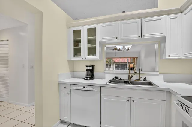 a utility room with sink dryer and washer
