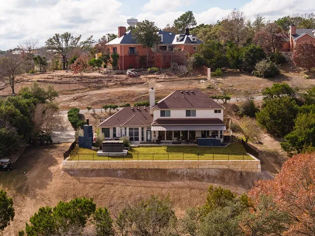 an aerial view of residential houses with yard and swimming pool