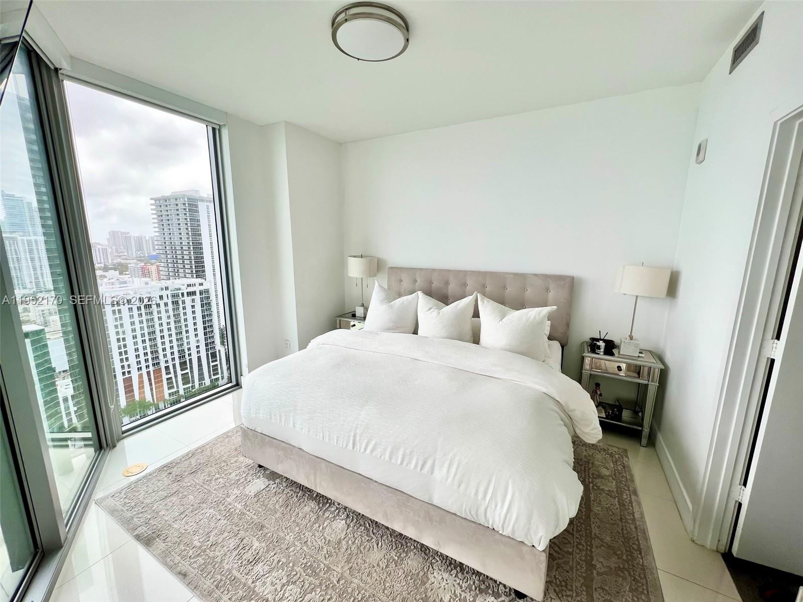 2900 Northeast 7th Avenue, Unit 2708 Miami, FL 33137 - Photo 12 of 25 a bedroom with a bed and a window