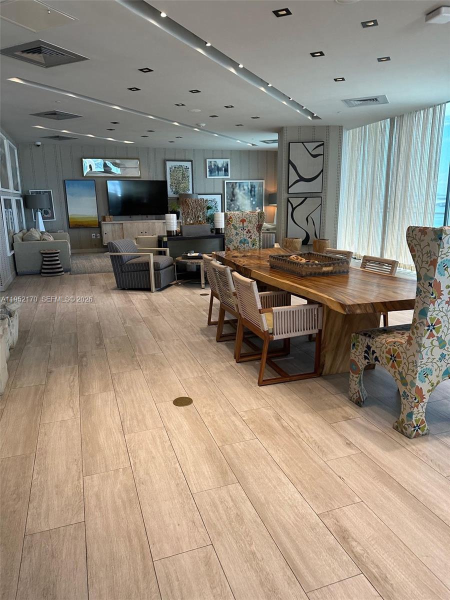 2900 Northeast 7th Avenue, Unit 2708 Miami, FL 33137 - Photo 24 of 25 a room with lots of furniture and a wooden floor