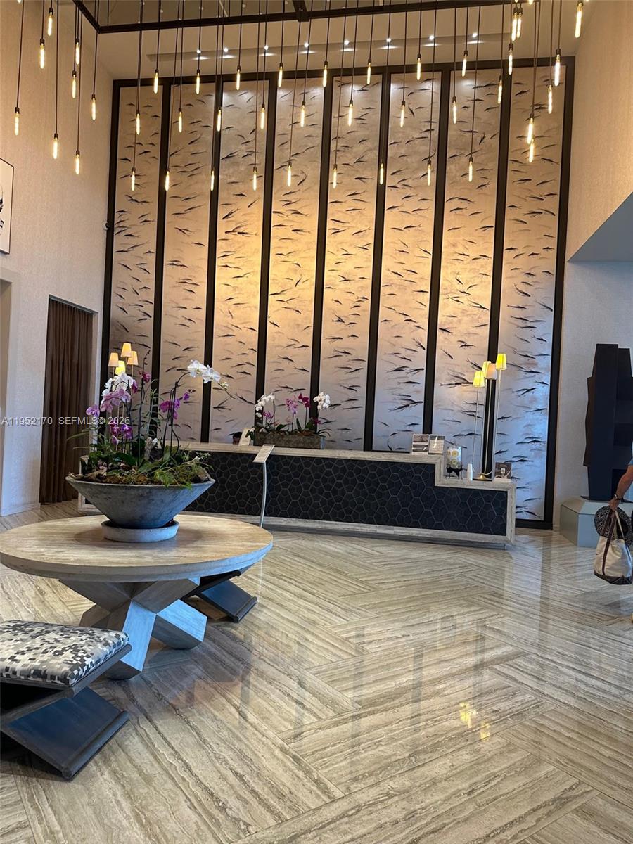 2900 Northeast 7th Avenue, Unit 2708 Miami, FL 33137 - Photo 5 of 25 a living room with furniture and a floor to ceiling window