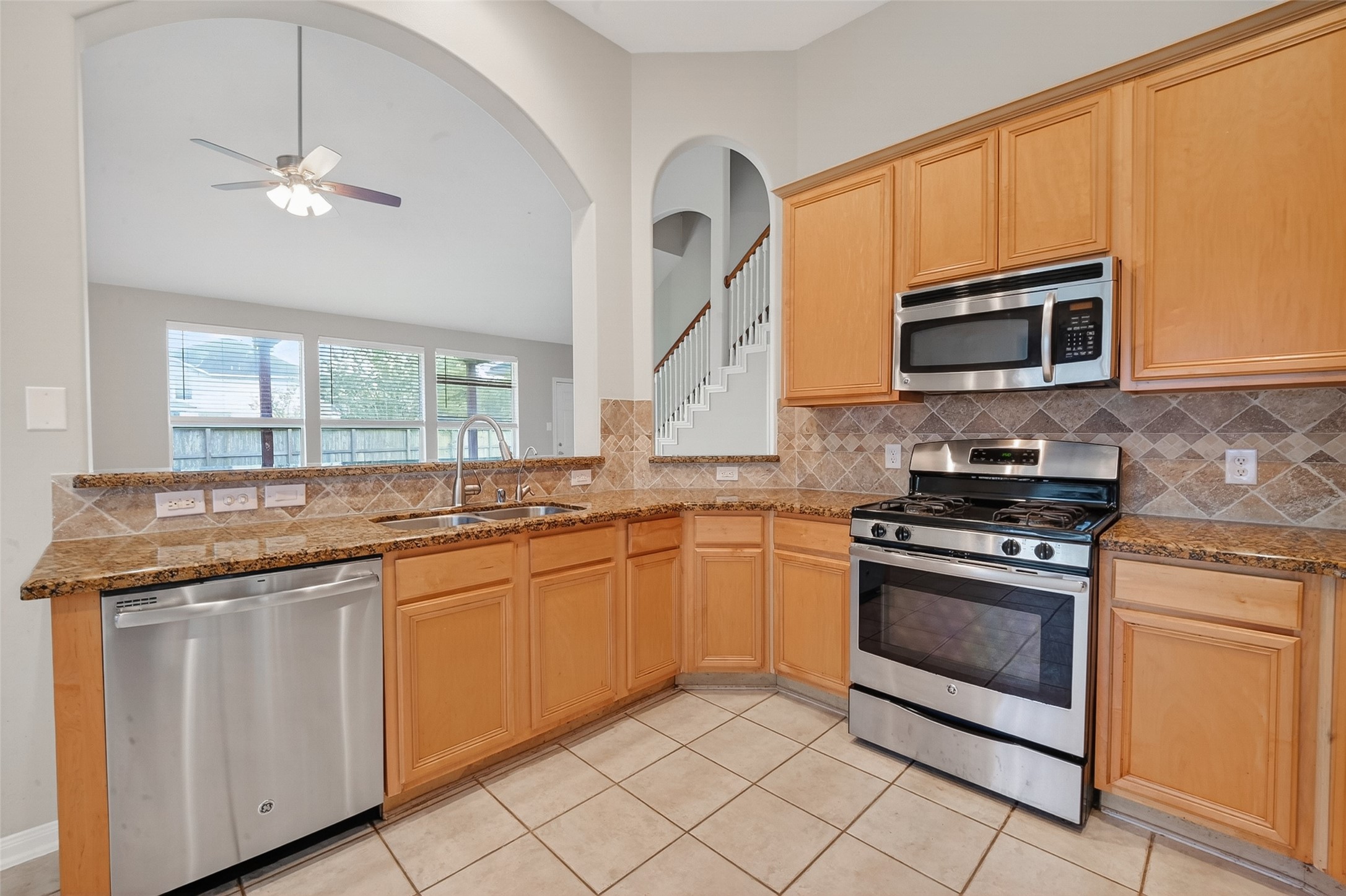 14308 Rocky Briar Lane Rosharon, TX 77583 - Photo 13 of 46 a kitchen with granite countertop a sink and stainless steel appliances