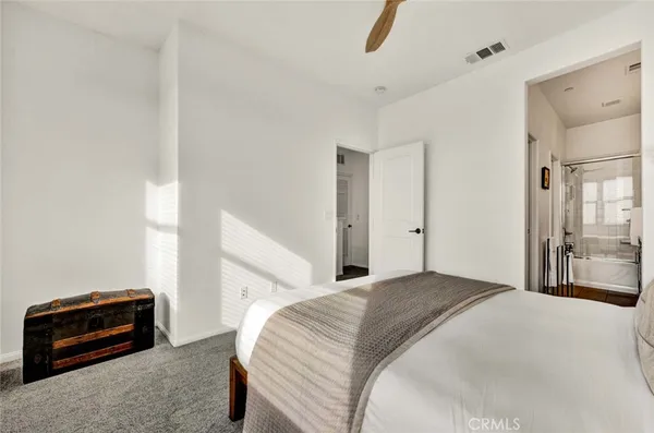 a bedroom with a bed and a couch