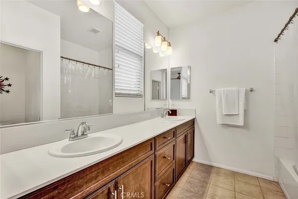 a bathroom with a double vanity sink and a mirror