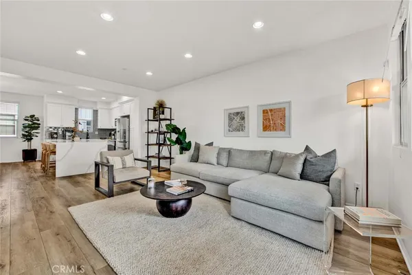 a living room with furniture and kitchen view