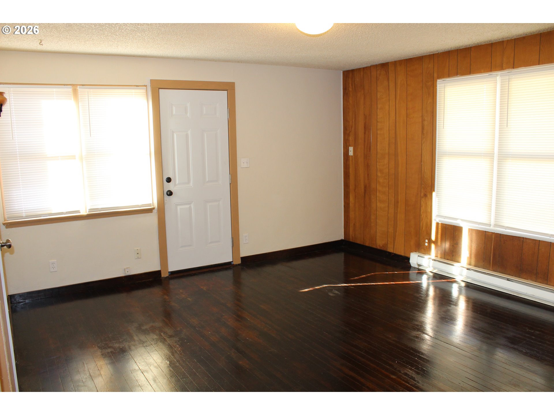 2906 East 12th Street Vancouver, WA 98661 - Photo 3 of 14 a view of an empty room with wooden floor and a window