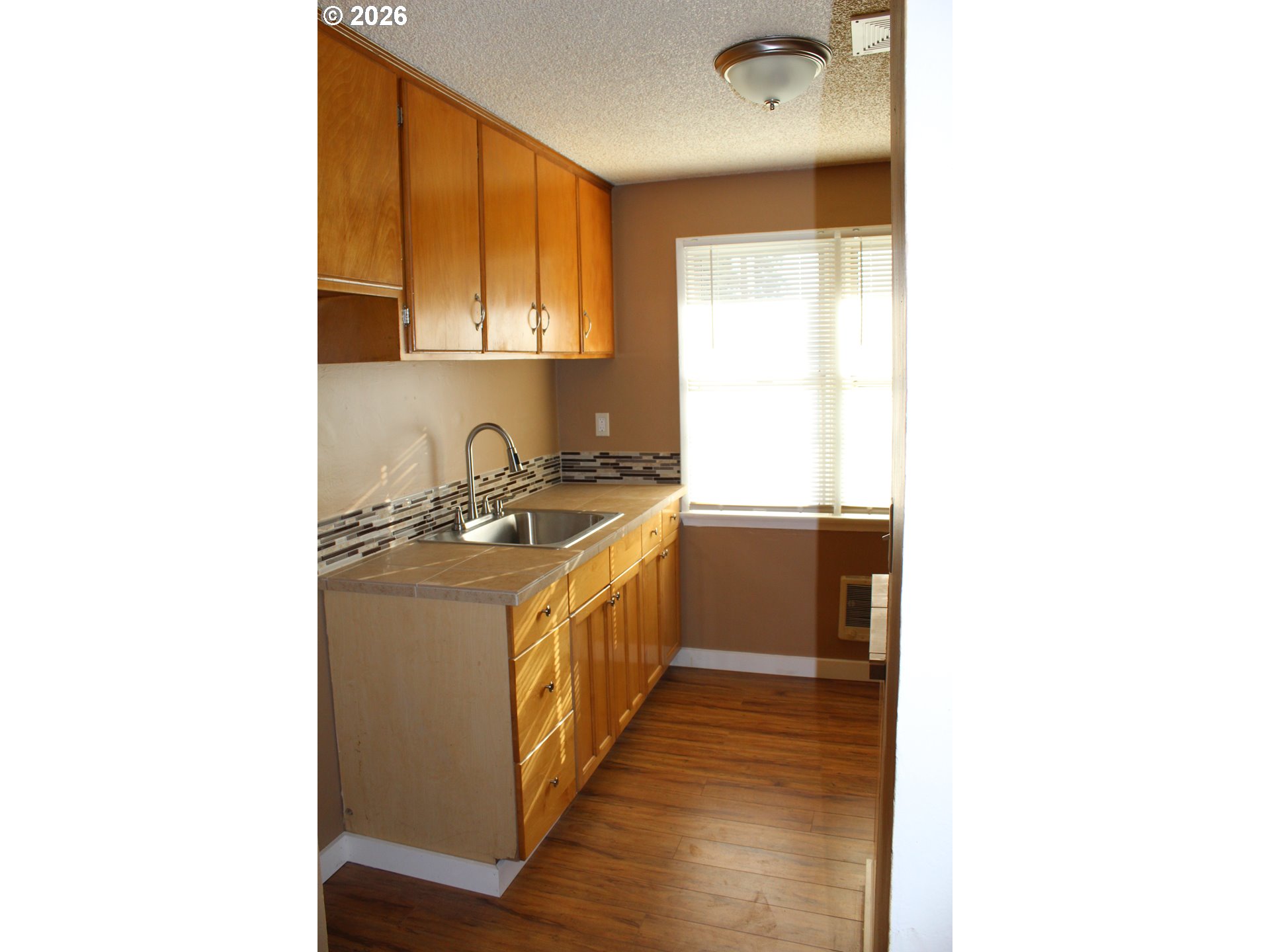 2906 East 12th Street Vancouver, WA 98661 - Photo 6 of 14 a kitchen with a sink cabinets and a window