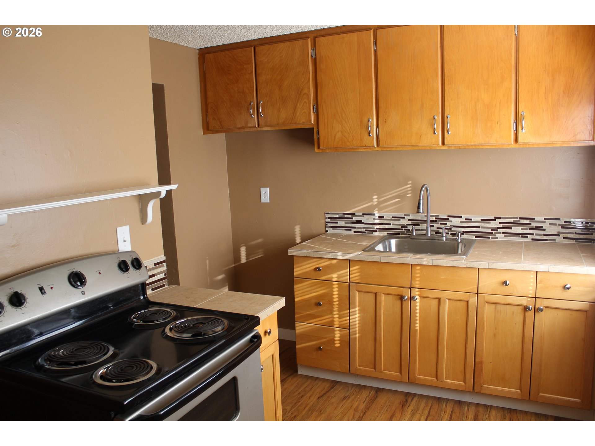 2906 East 12th Street Vancouver, WA 98661 - Photo 7 of 14 a kitchen with stainless steel appliances granite countertop a sink stove and cabinets