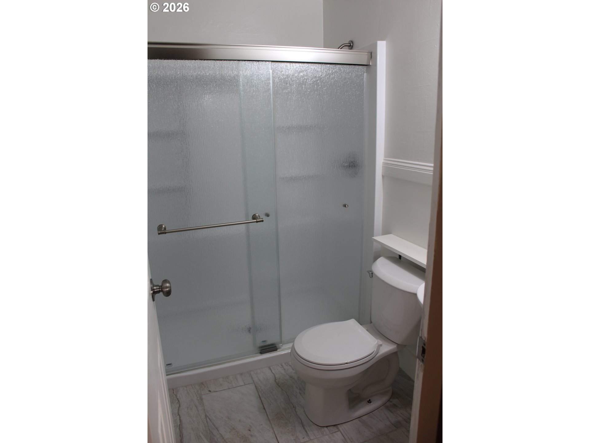 2906 East 12th Street Vancouver, WA 98661 - Photo 9 of 14 a bathroom with a toilet and a shower