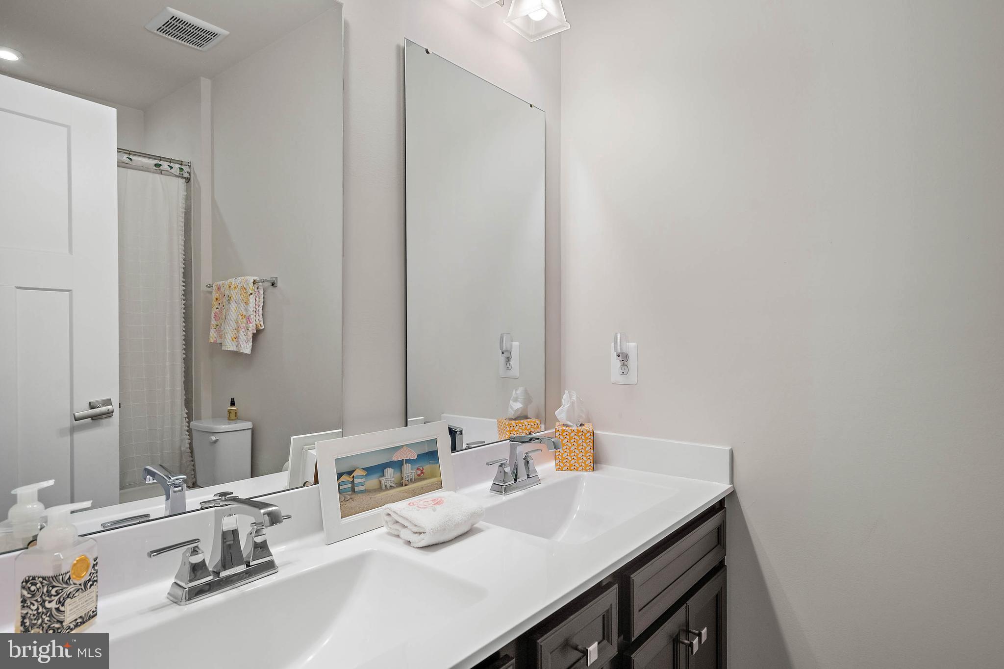 12159 Snug Harbor Road Berlin, MD 21811 - Photo 26 of 72 a bathroom with a sink and a mirror