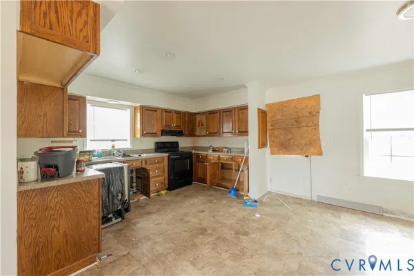 a kitchen with a sink stove top oven and refrigerator