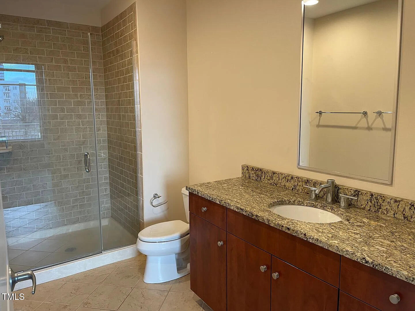 400 West North Street, Unit 634 Raleigh, NC 27603 - Photo 2 of 9 a bathroom with a granite countertop sink toilet a mirror and shower
