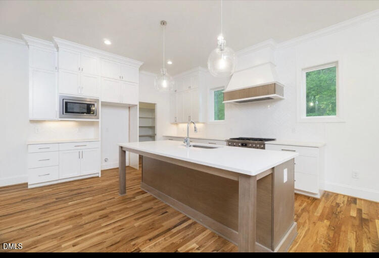 1407 Onslow Road Raleigh, NC 27606 - Photo 4 of 7 a kitchen with stainless steel appliances granite countertop a sink a stove and a refrigerator