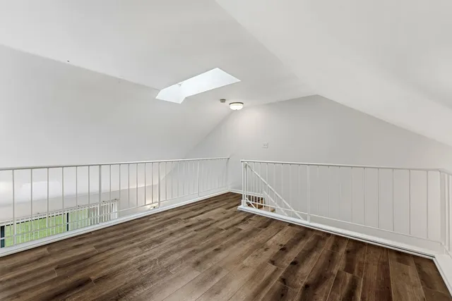 a view of a room with wooden floor