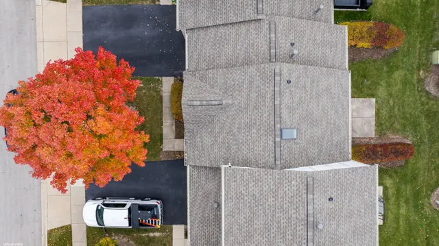 an aerial view of a residential houses with city view