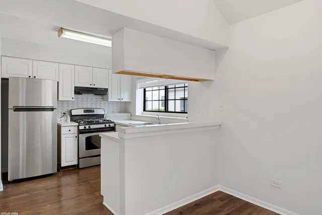 a kitchen with stainless steel appliances a refrigerator stove and microwave