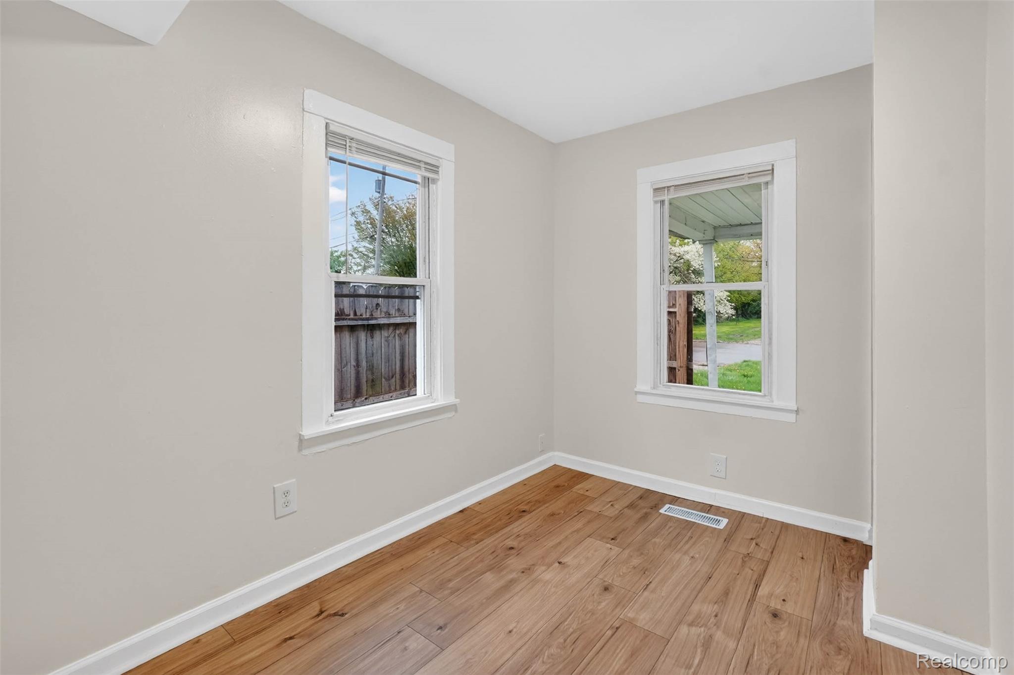 4910 Hughes Road Lansing, MI 48910 - Photo 11 of 27 Unfurnished room with baseboards and light wood finished floors