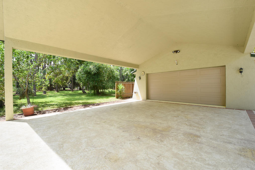 15429 Jupiter Farms Road Jupiter, FL 33478 - Photo 22 of 59 a view of a house with a yard and garage