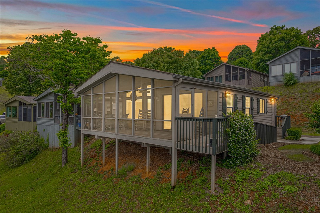 1230 Melton Road, Unit 25 West Union, SC 29696 - Photo 13 of 46 Perched on a verdant hillside, this charming residence boasts a spacious screened-in porch perfect for enjoying sunsets.