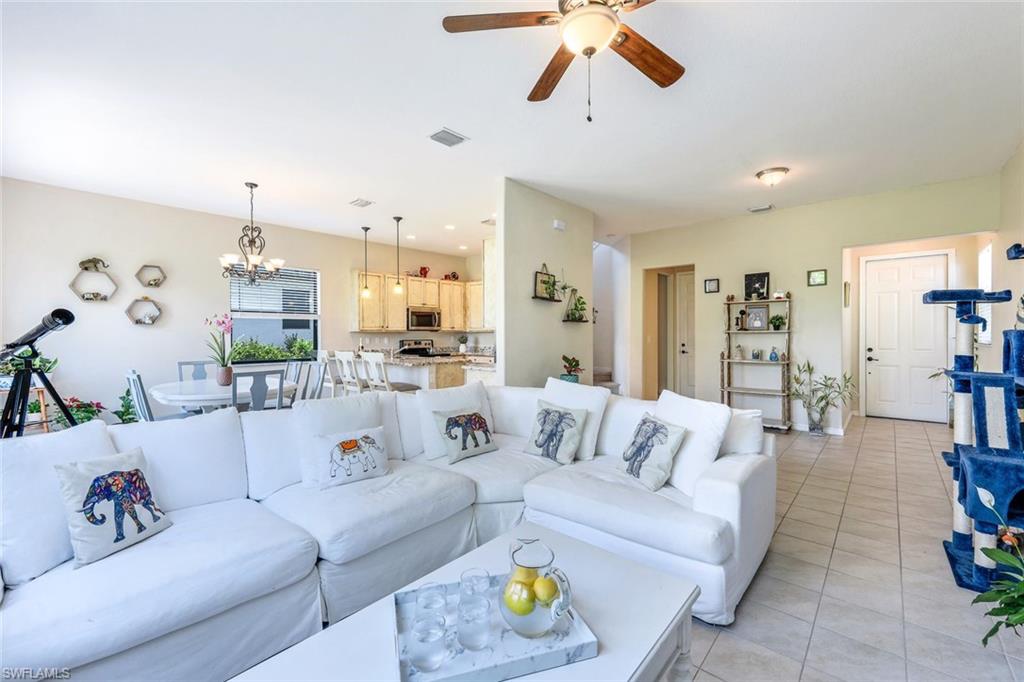 5459 Useppa Drive Ave Maria, FL 34142 - Photo 3 of 21 a living room with furniture and a chandelier