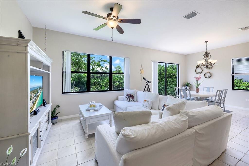 5459 Useppa Drive Ave Maria, FL 34142 - Photo 4 of 21 a living room with furniture chandelier and a large window