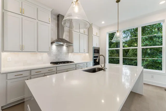 a kitchen with stainless steel appliances white cabinets and a stove