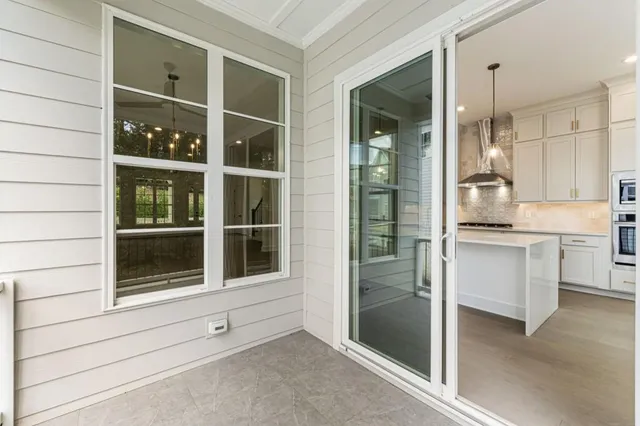 an empty room with a ceiling fan and carpet