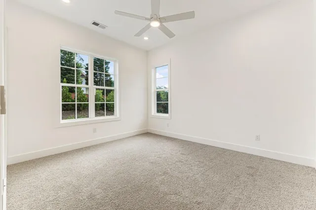 an empty room with a empty space and windows