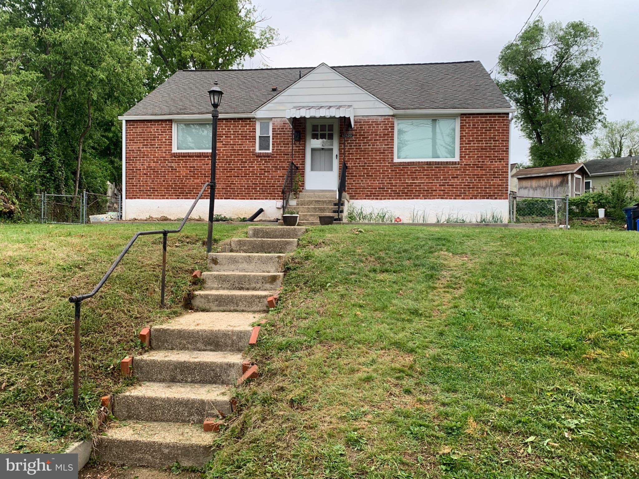 Charming brick home with inviting steps.