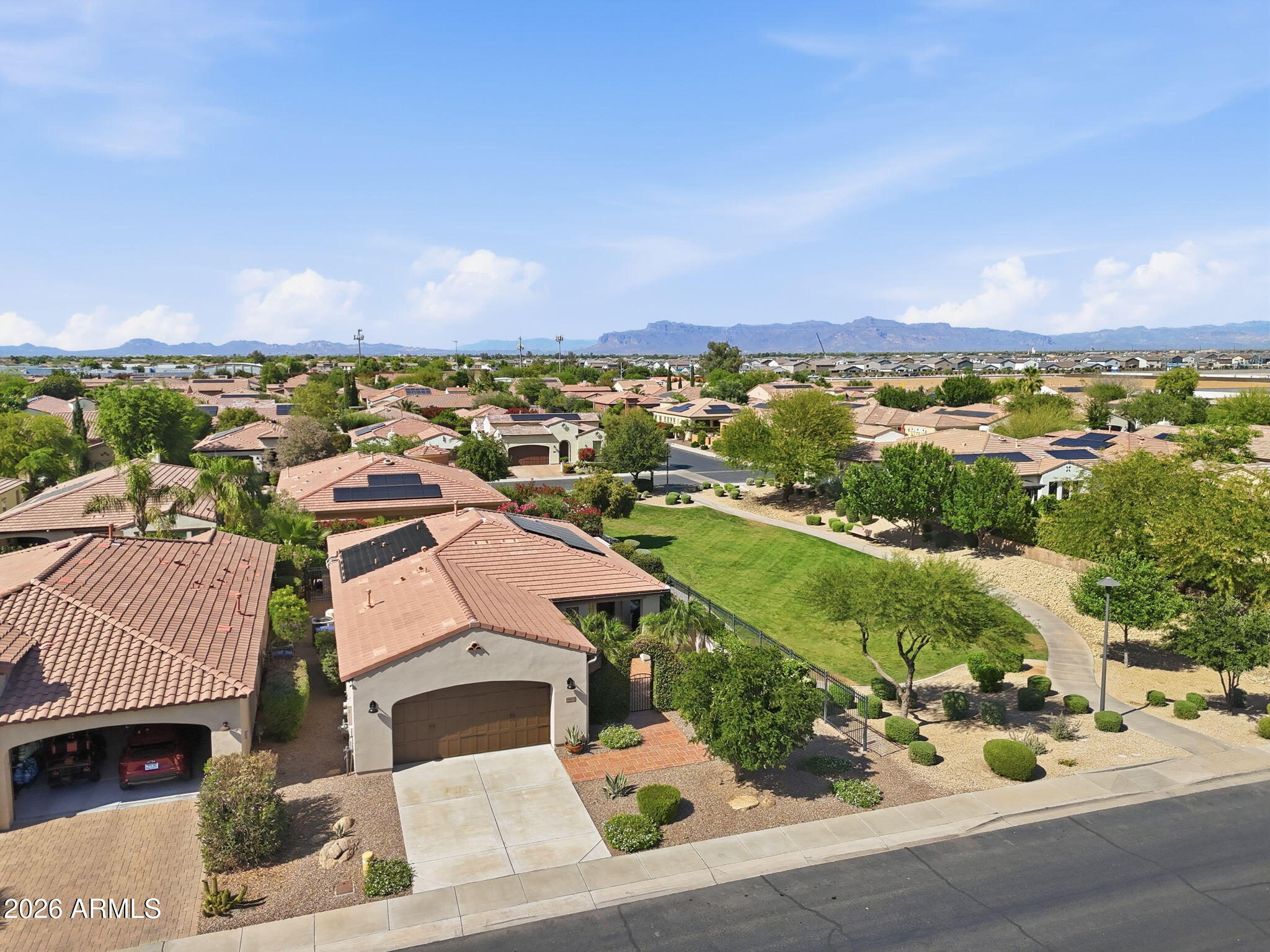 1694 East Grand Ridge Road Queen Creek, AZ 85140 - Photo 6 of 61 an aerial view of a house with a garden and lake view