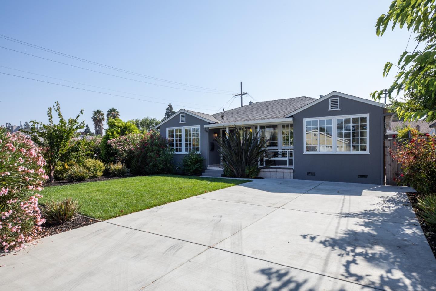 3432 Bay Road Redwood City, CA 94063 - Photo 1 of 33 a front view of a house with a yard and potted plants