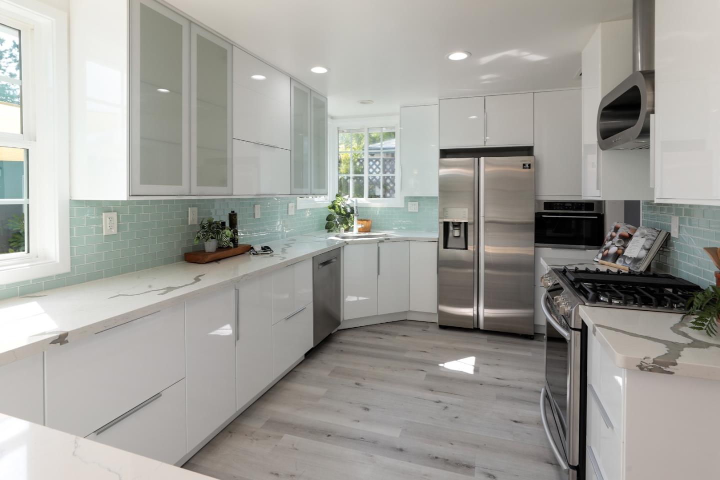 3432 Bay Road Redwood City, CA 94063 - Photo 4 of 33 a kitchen with a refrigerator a sink a stove and cabinets