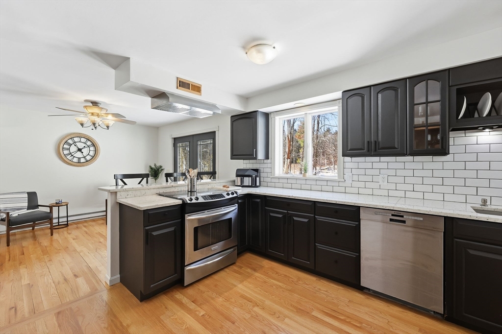 429 Moore Street Ludlow, MA 01056 - Photo 16 of 41 a kitchen with stainless steel appliances granite countertop a stove and a sink