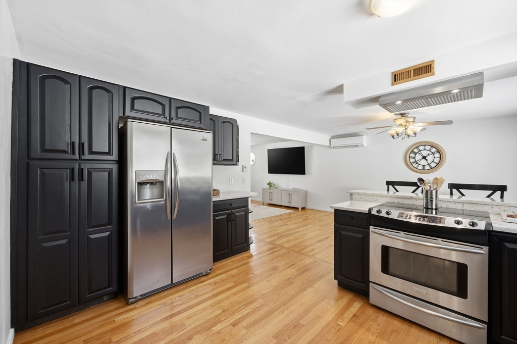 429 Moore Street Ludlow, MA 01056 - Photo 18 of 41 a kitchen with stainless steel appliances granite countertop a stove a refrigerator and a microwave