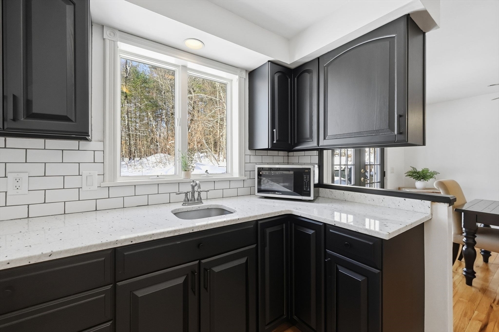 429 Moore Street Ludlow, MA 01056 - Photo 19 of 41 a kitchen with a sink stove and cabinets