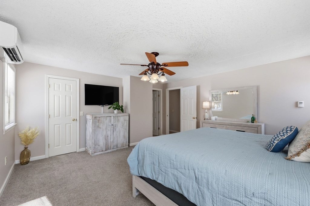 429 Moore Street Ludlow, MA 01056 - Photo 29 of 41 a bedroom with a bed and a flat tv screen on dresser
