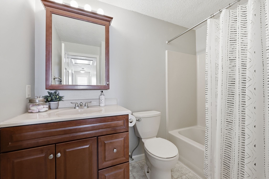 429 Moore Street Ludlow, MA 01056 - Photo 38 of 41 a bathroom with a granite countertop toilet a sink and a mirror