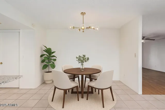 a view of a room with a table and chairs
