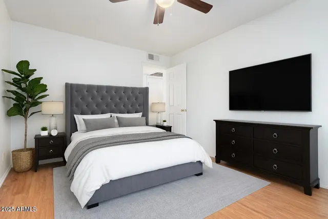 a bedroom with a bed and a flat screen tv