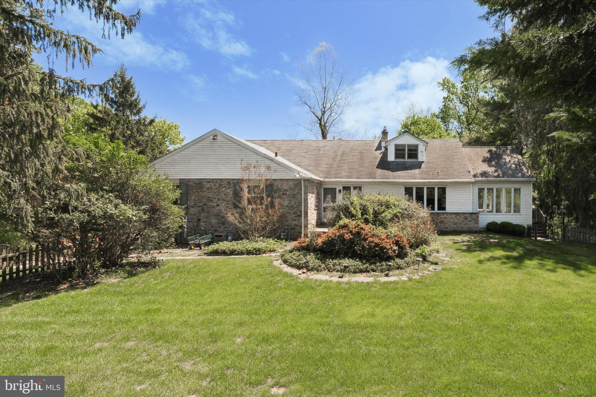 a front view of a house with a garden and porch