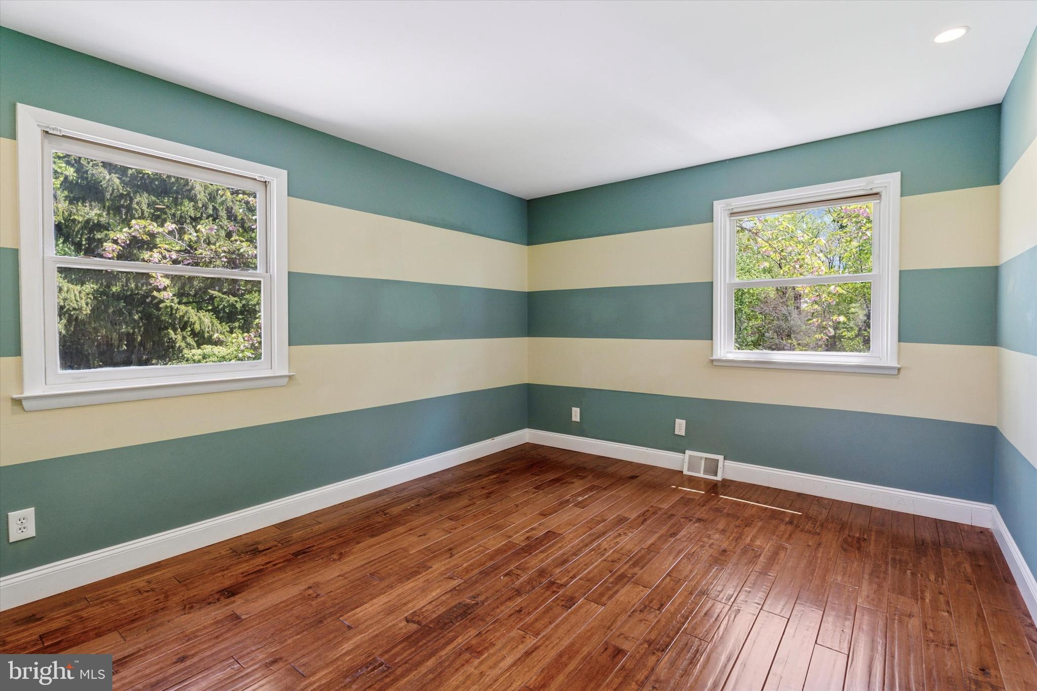 317 Hilltop Road Paoli, PA 19301 - Photo 13 of 25 an empty room with wooden floor and windows