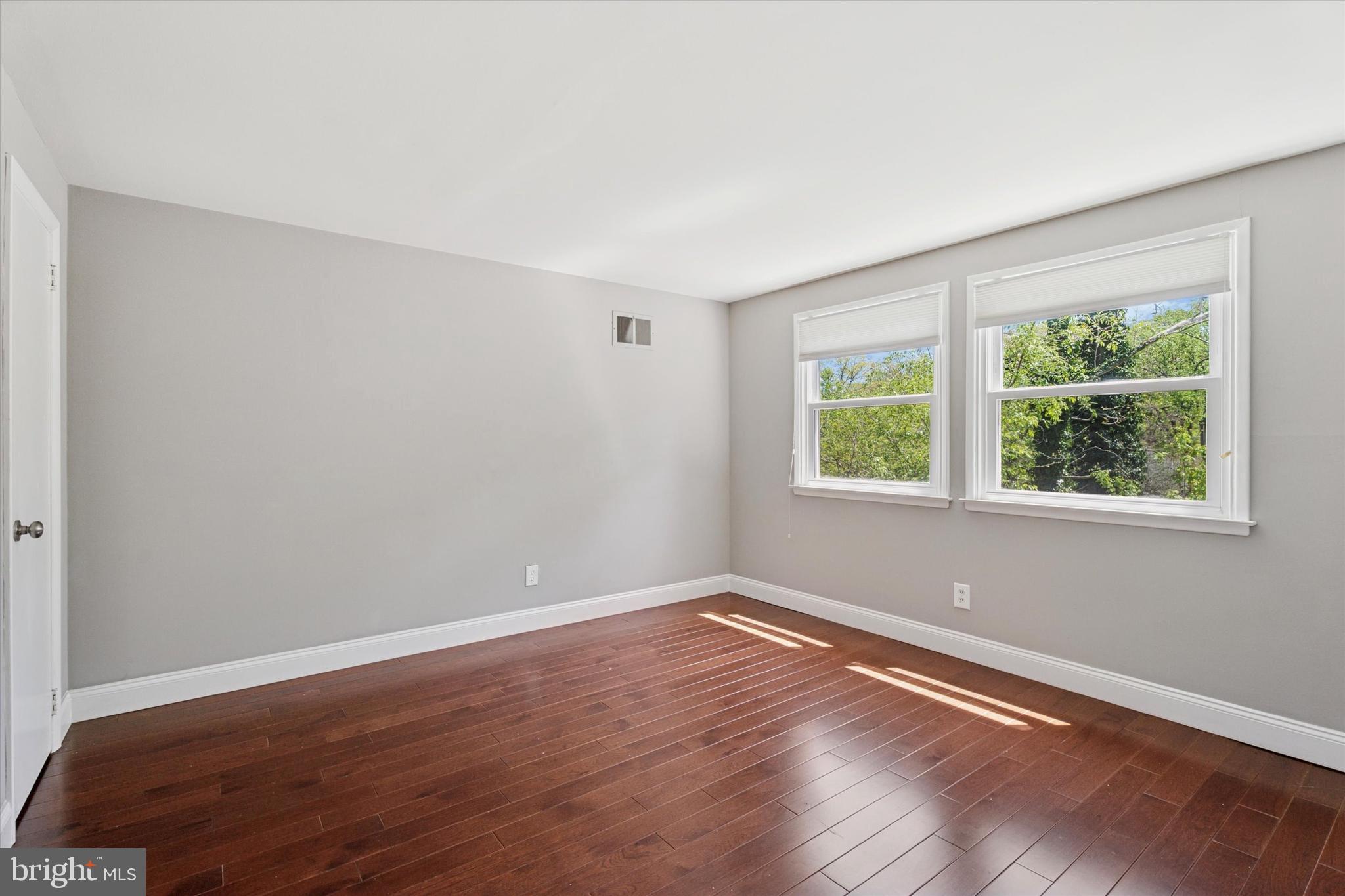 317 Hilltop Road Paoli, PA 19301 - Photo 15 of 25 a view of an empty room with wooden floor and a window